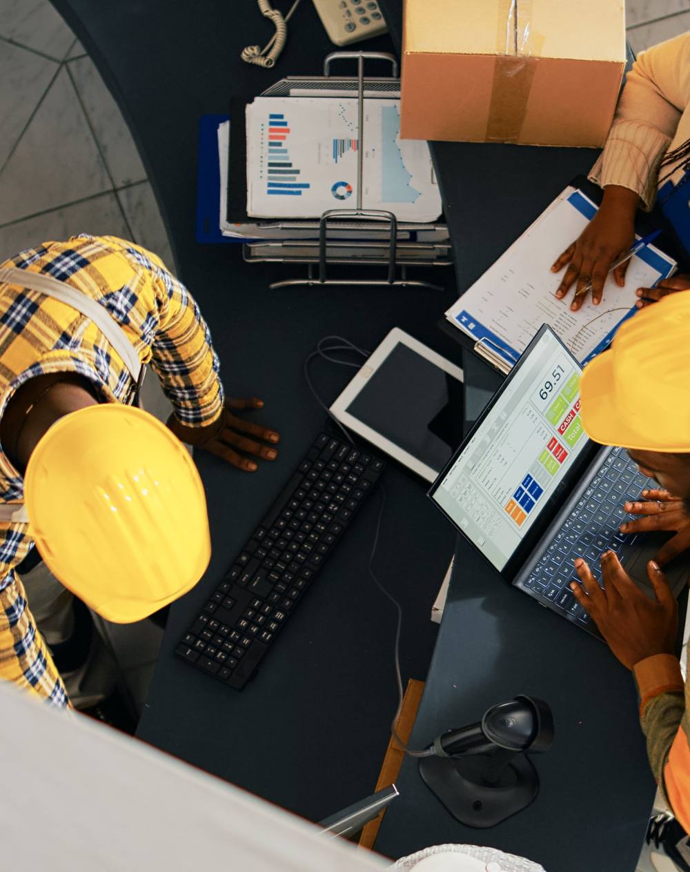 Site and logistics staff reviewing performance data at a workstation